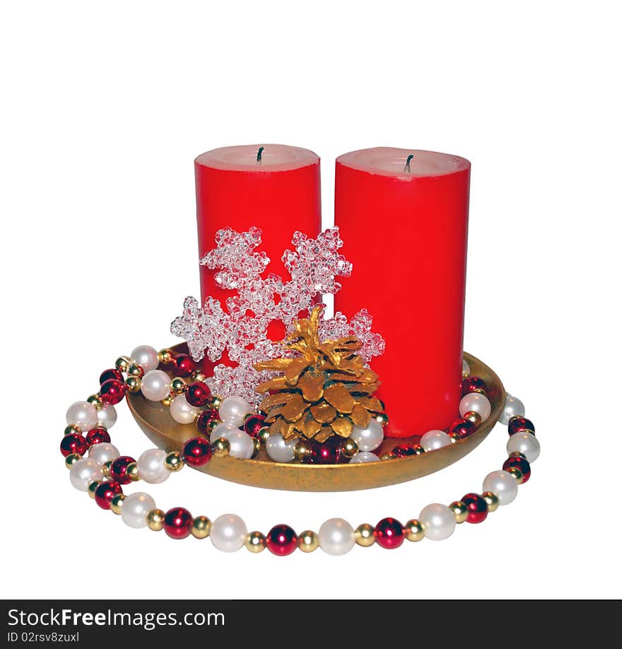 Christmas composition - two big red candles, glass snowflake, beads and gilded pinecone. Christmas composition - two big red candles, glass snowflake, beads and gilded pinecone