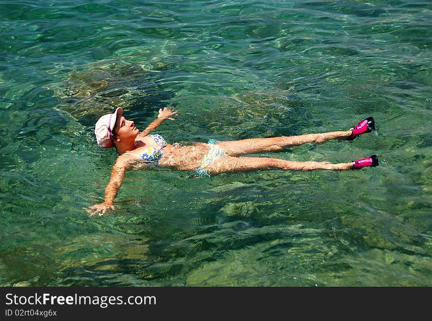 A girl floating in Adriatic waters of Montenegro. A girl floating in Adriatic waters of Montenegro