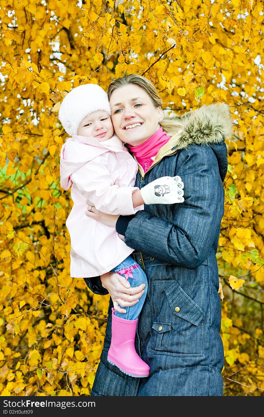 Portrait of woman with toddler in autumnal nature