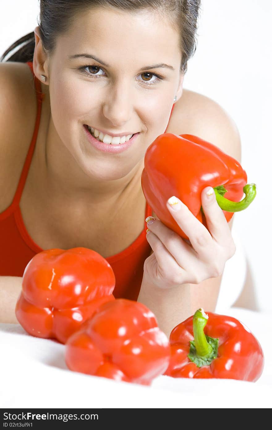 Portrait of lying down woman with peppers