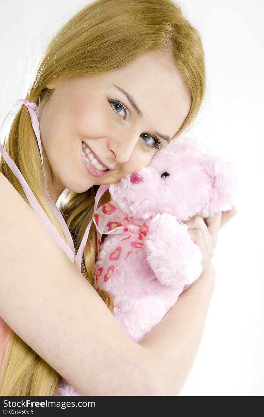 Portrait of smiling young woman with teddy bear