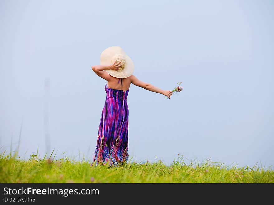 Young beautiful girl on a meadow