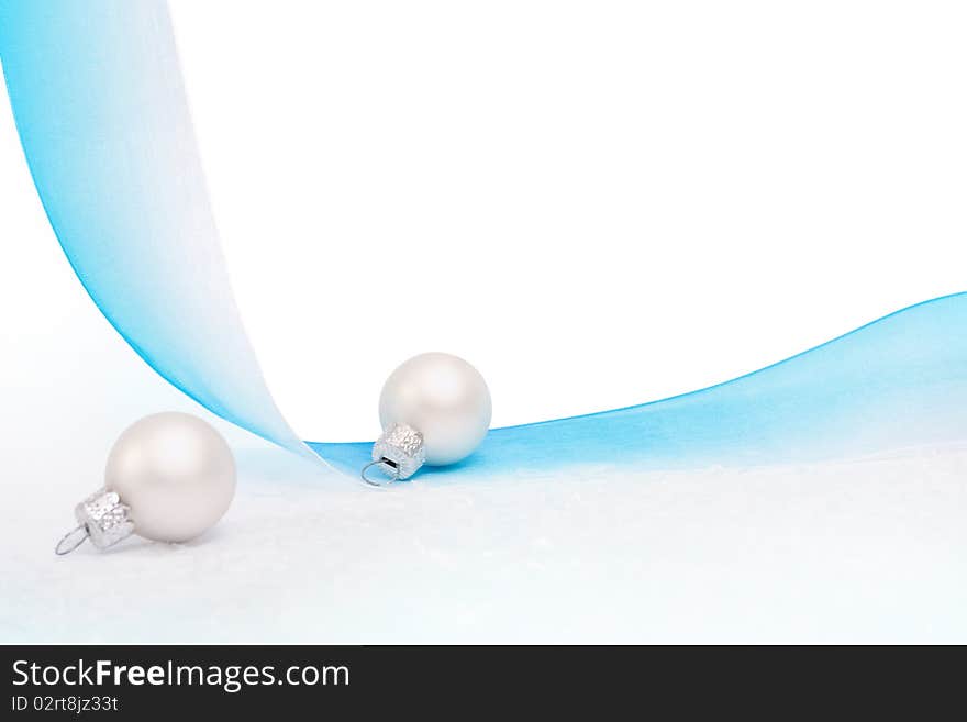 Silver bauble, and blue ribbon on a white background. Silver bauble, and blue ribbon on a white background.