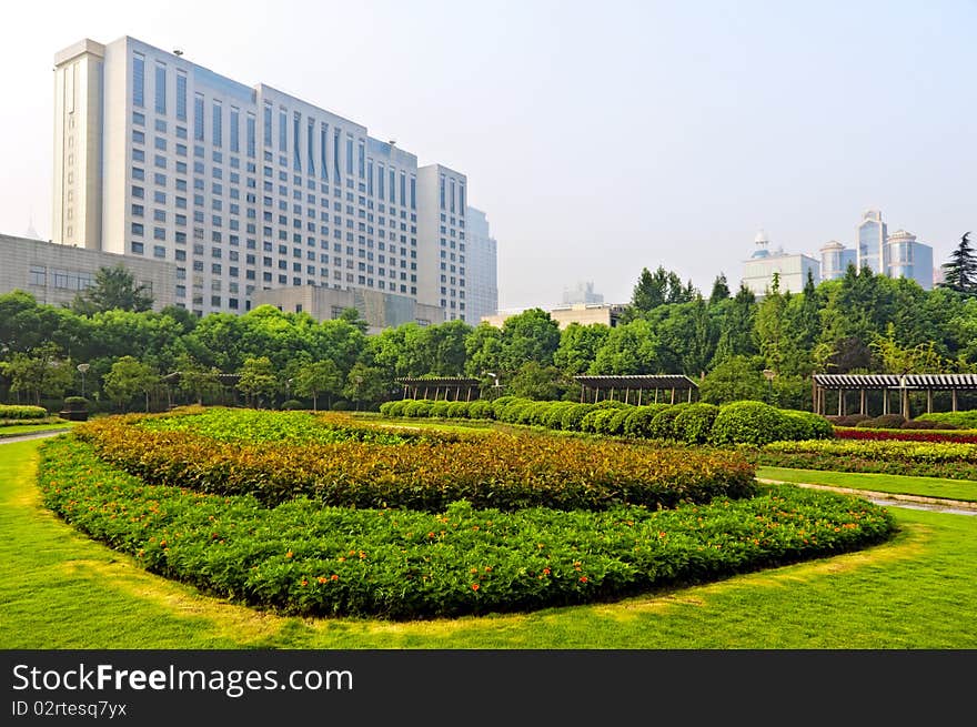 Beautiful garden surrounds a building in an urban area. Beautiful garden surrounds a building in an urban area