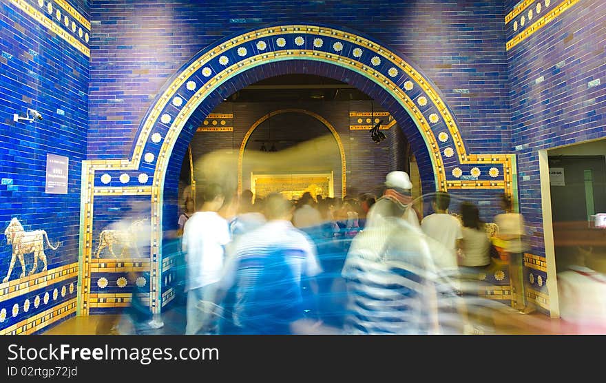 Blurred crowd through blue palatial arch of ancient rome