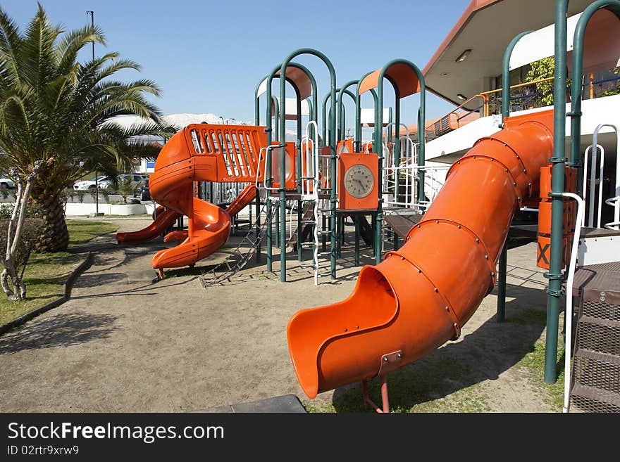 Public park with infantile games in commercial center. Public park with infantile games in commercial center