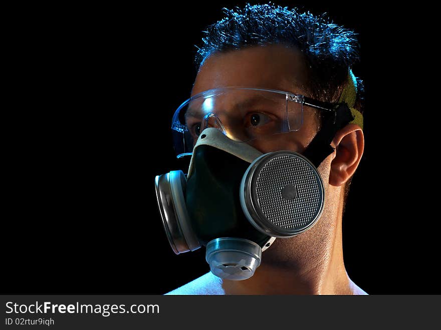 A man in a respirator and glasses suffering from smoke and heat in Moscow. Isolated on black. A man in a respirator and glasses suffering from smoke and heat in Moscow. Isolated on black.