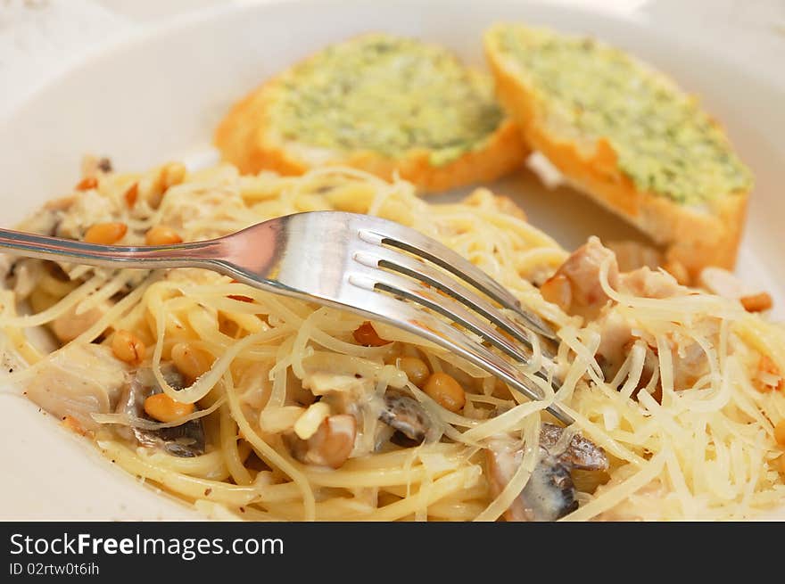 Spaghetti with mushroom sauce and cedar nuts