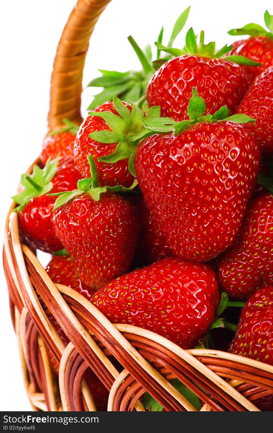 Ripe strawberry in wicker basketbasket isolated on a white background