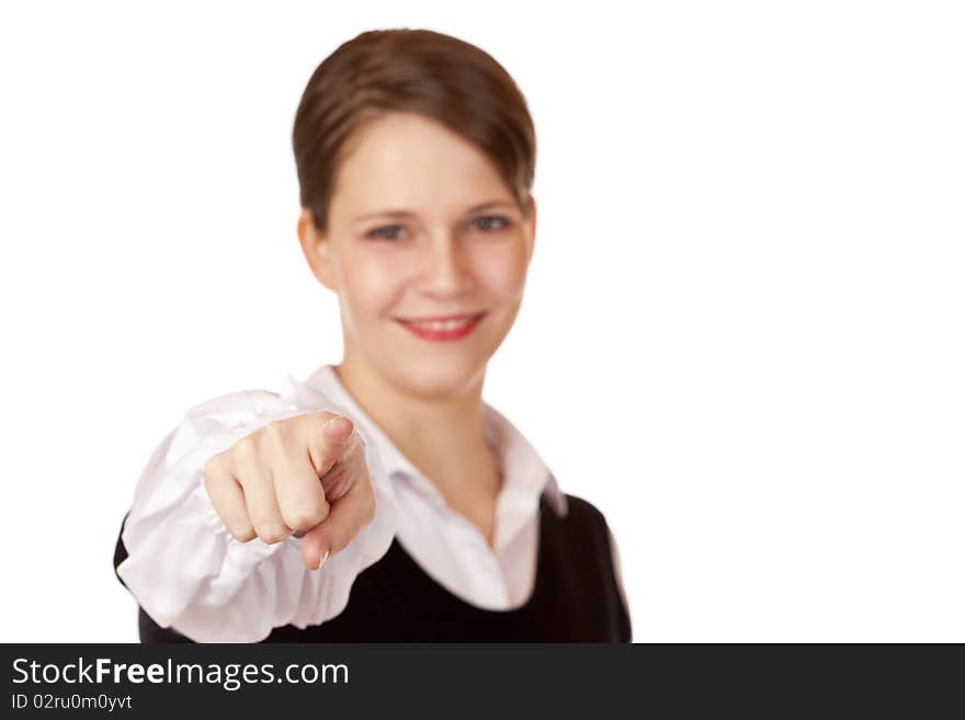 Cheerful business woman smiles and points with finger on camera. Isolated on white background.