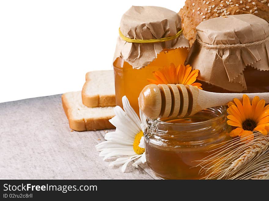 Several flowers and honey on table