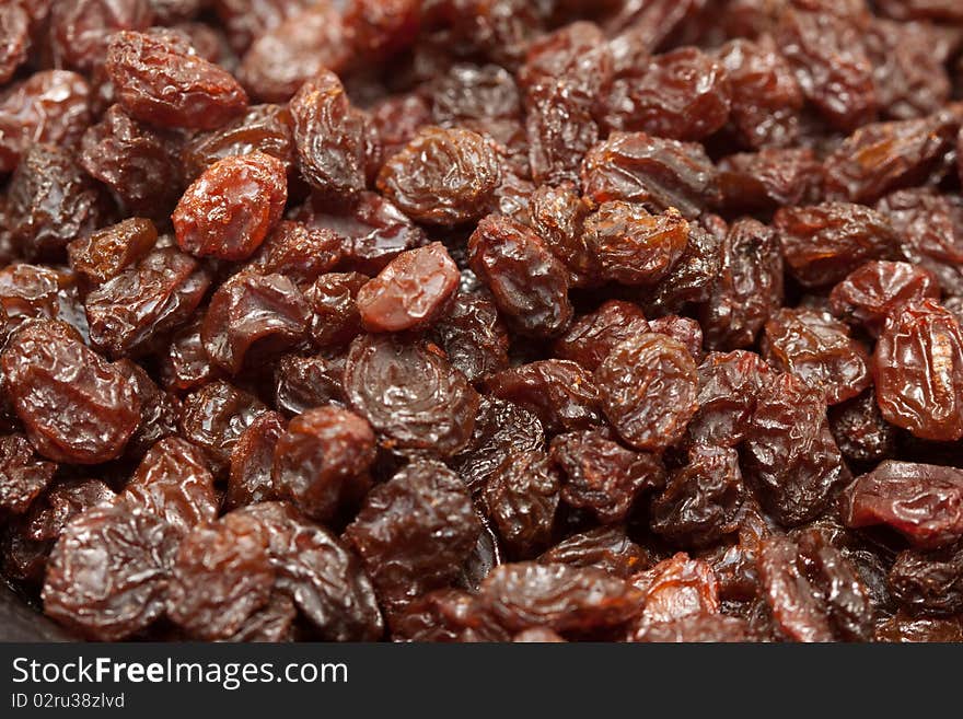 A macro shot of a heap of raisins.