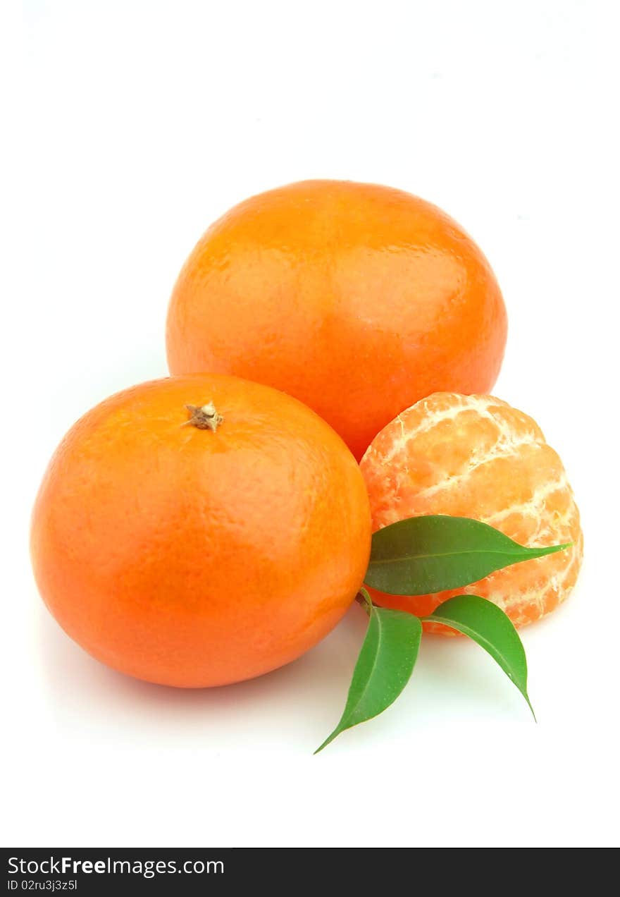 Tangerines entirely and segments and with leaves close up