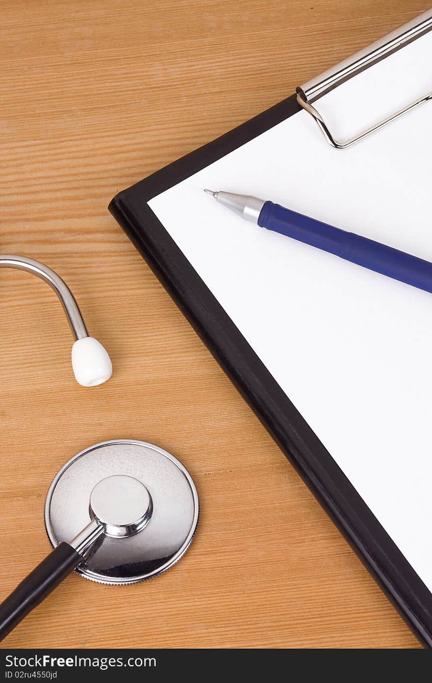 Black stethoscope and paper on table