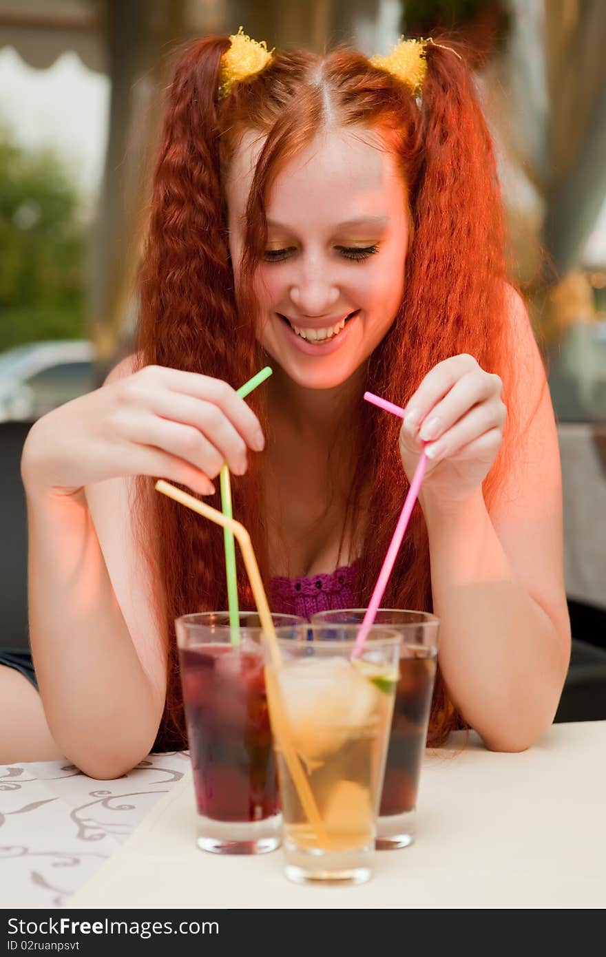 Girl with cocktails in cafe