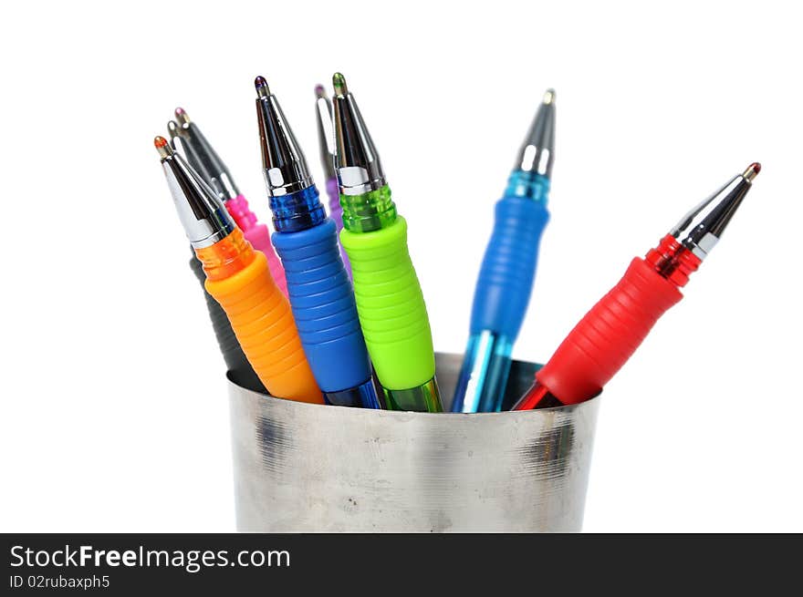 Colored ball-pen in steel cup over white