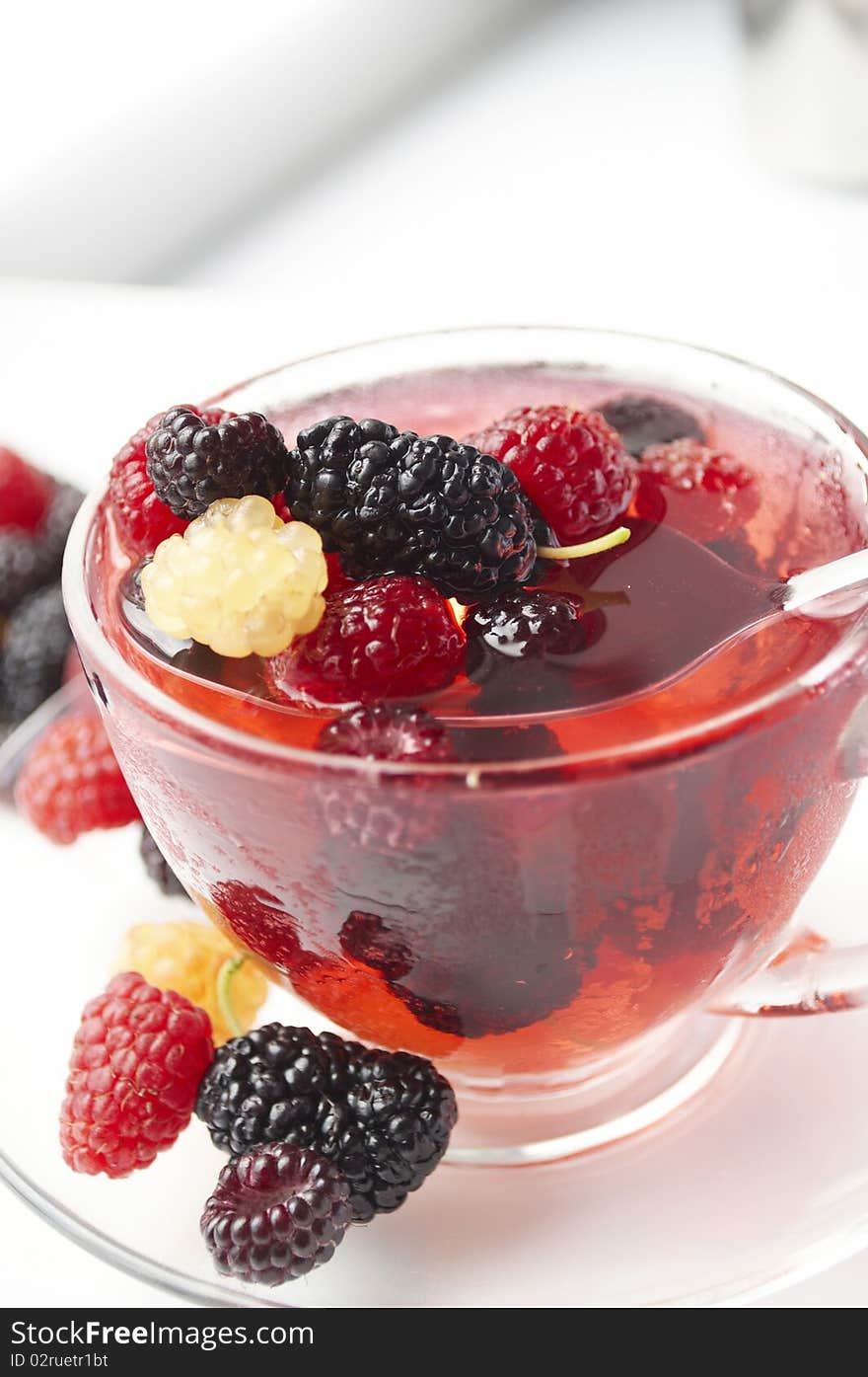 Ripe forest berries in the glass cup