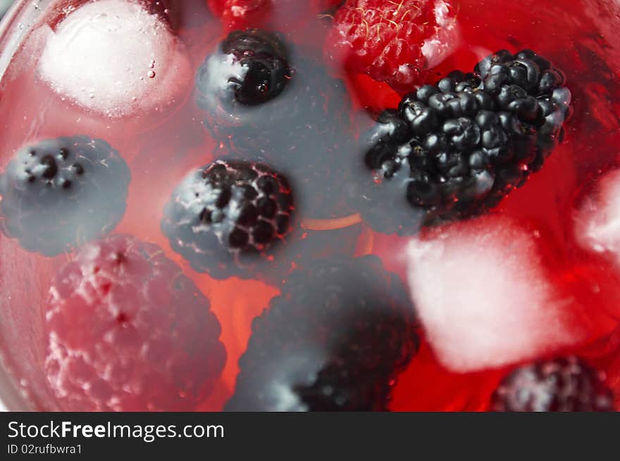 Ripe forest berries in the glass cup