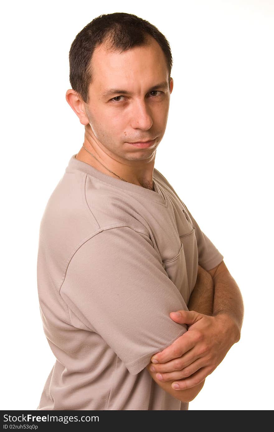 A man in a grey sport shirt sits in a studio. A man in a grey sport shirt sits in a studio