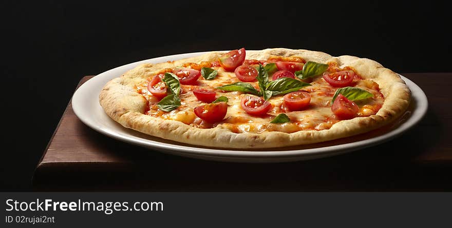 Still life with pizza and basil and cheese