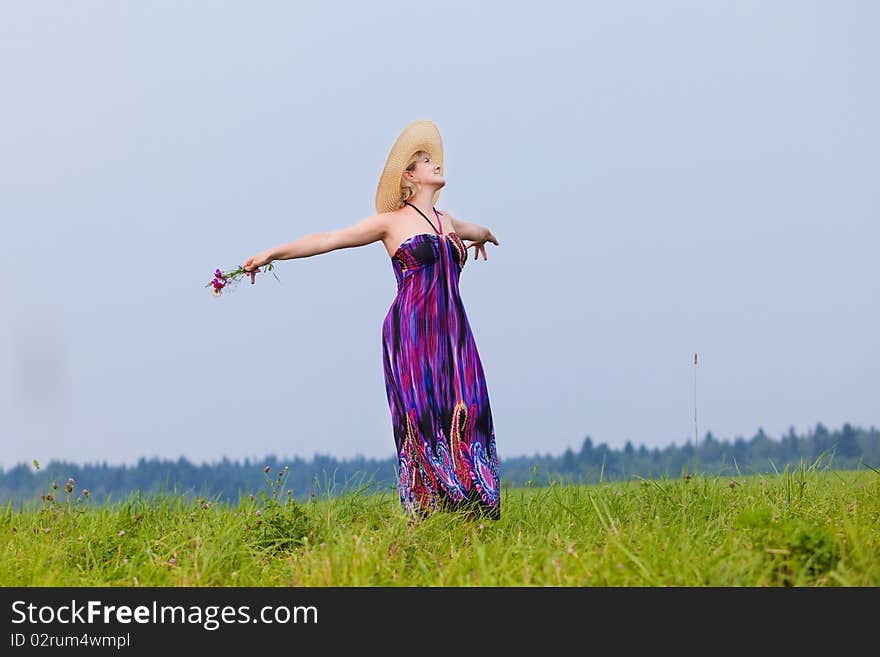 Young beautiful girl on a meadow