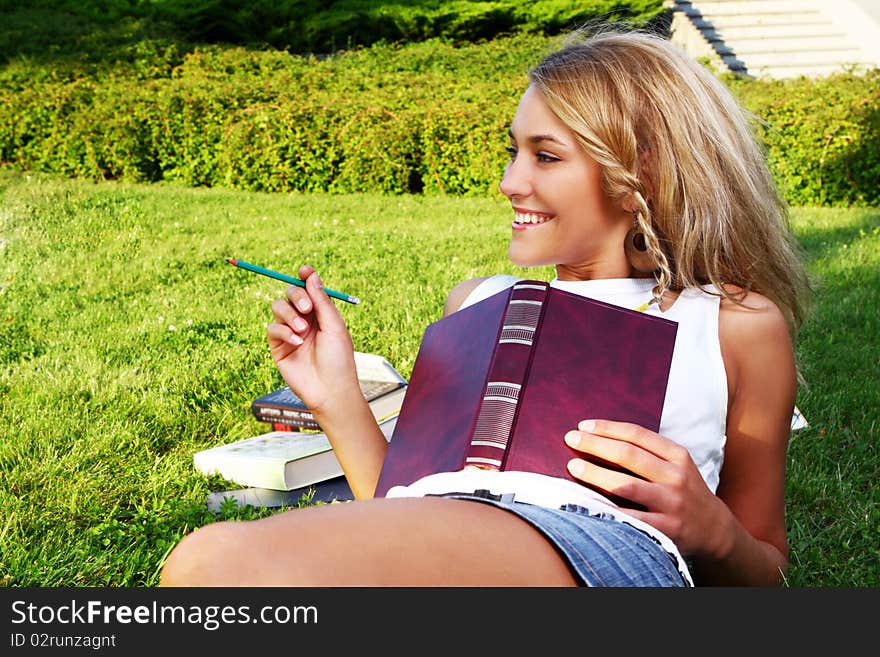 Young and beautiful girl doing home work