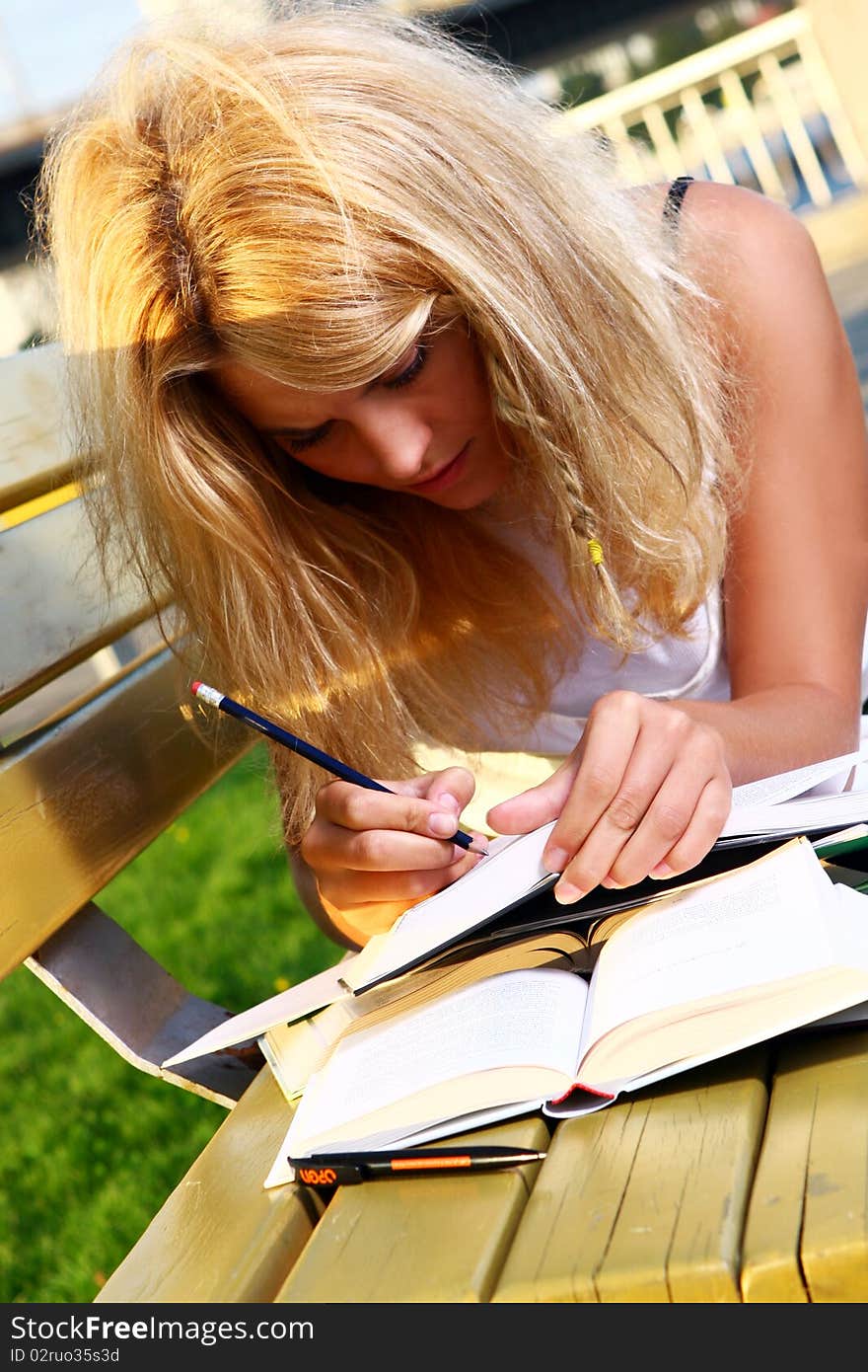 Young and beautiful girl doing school work