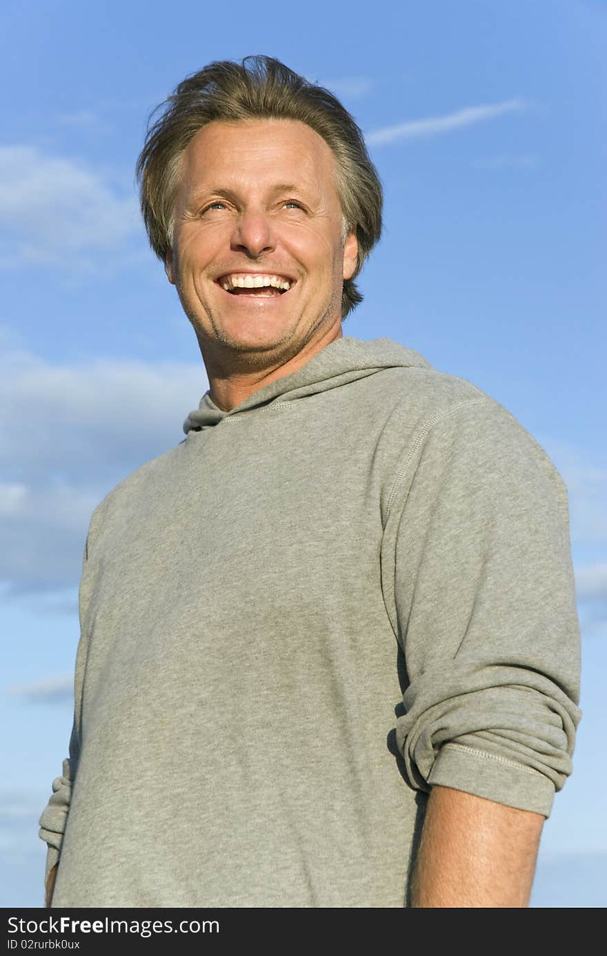 A colour portrait photo of a happy smiling man in his forties. A colour portrait photo of a happy smiling man in his forties.