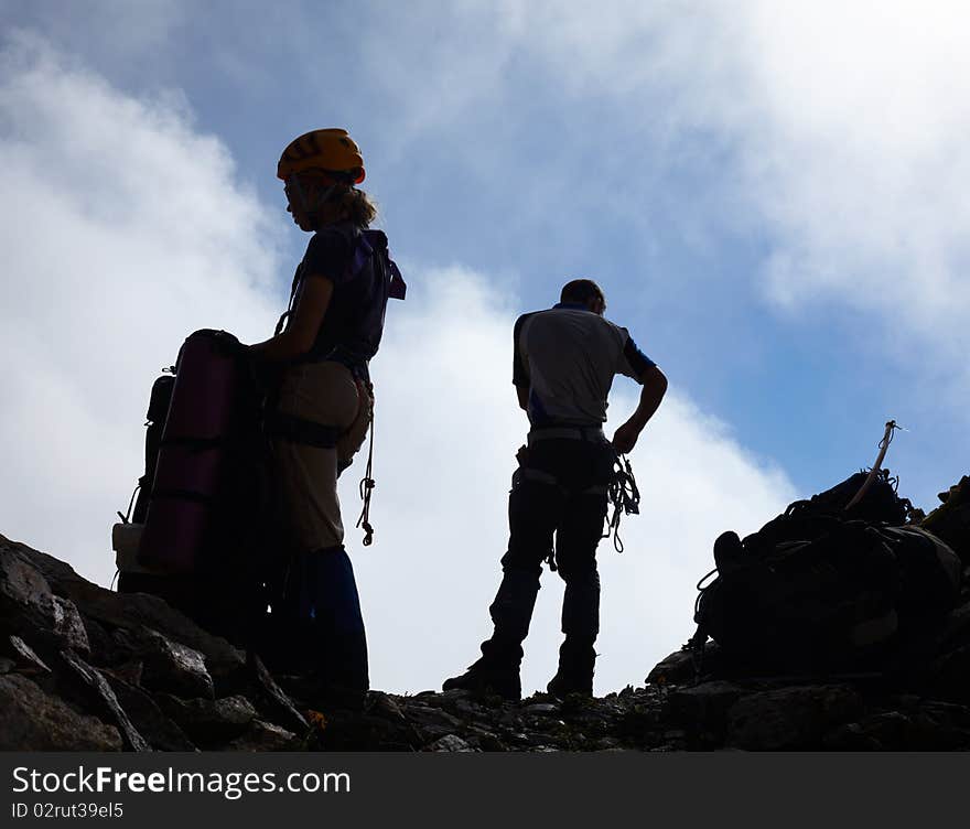 Couple of mountaneers on the top of mountain