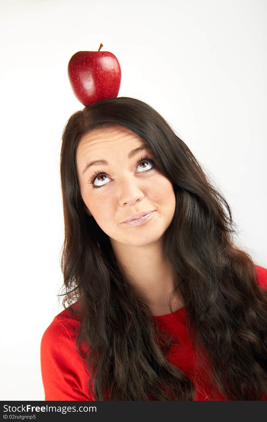 A healthy beautiful happy woman is eating an red apple. A healthy beautiful happy woman is eating an red apple