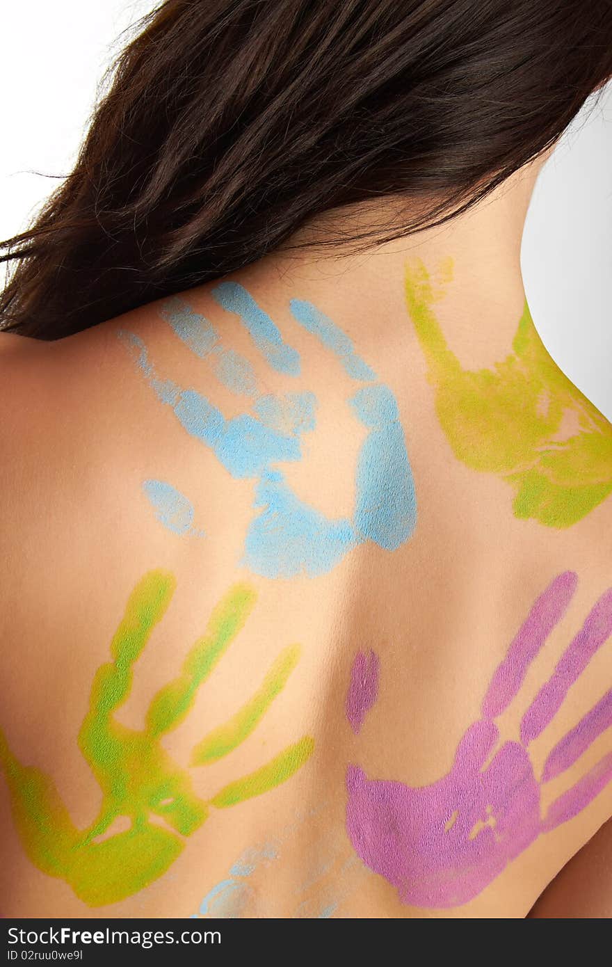 The back of a young woman with bodypainting hands. The back of a young woman with bodypainting hands