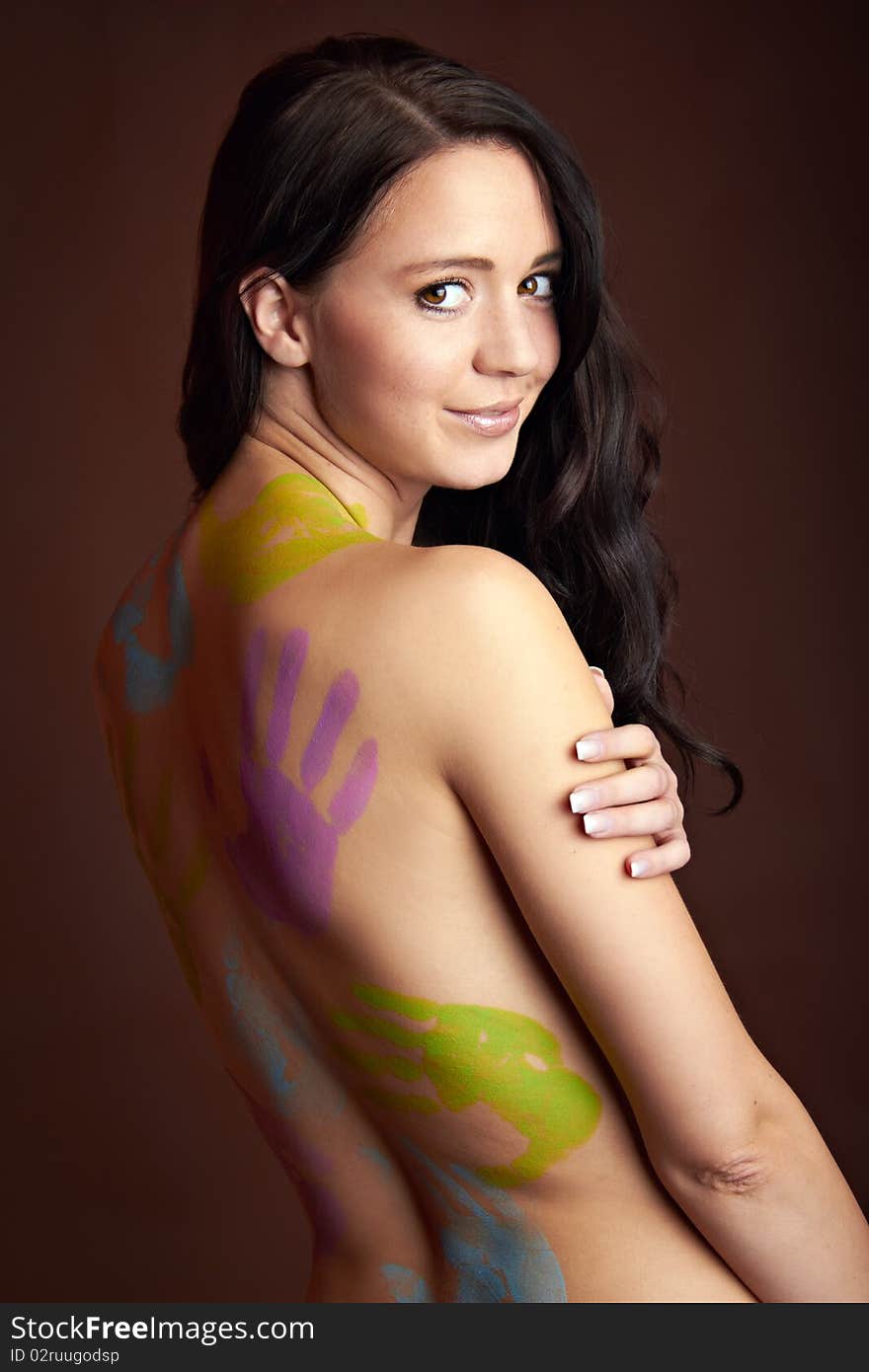 The back of a young woman with bodypainting hands. The back of a young woman with bodypainting hands