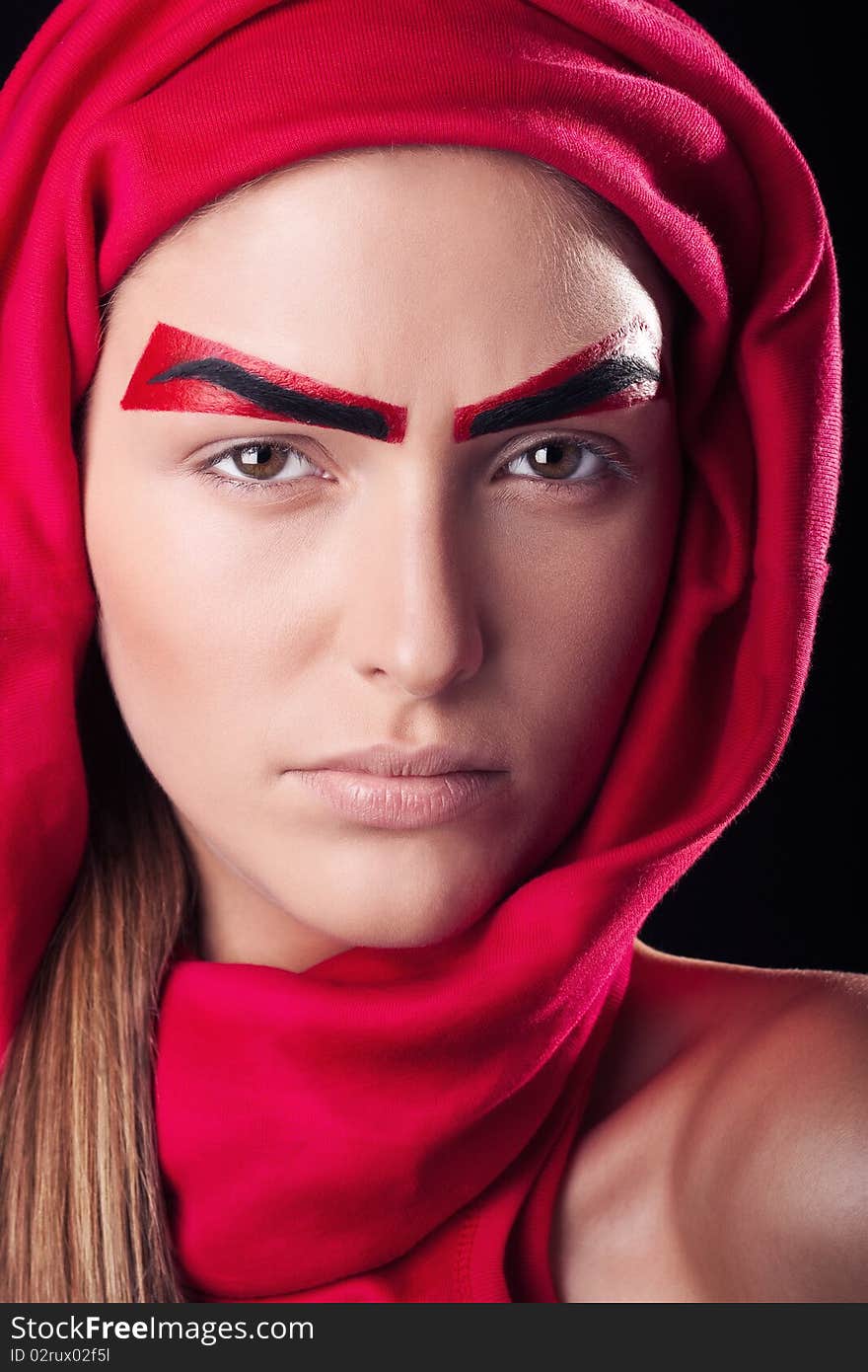 Art make-up on the person young, beautiful, girls. Red eyebrows on the person of the young and beautiful girl