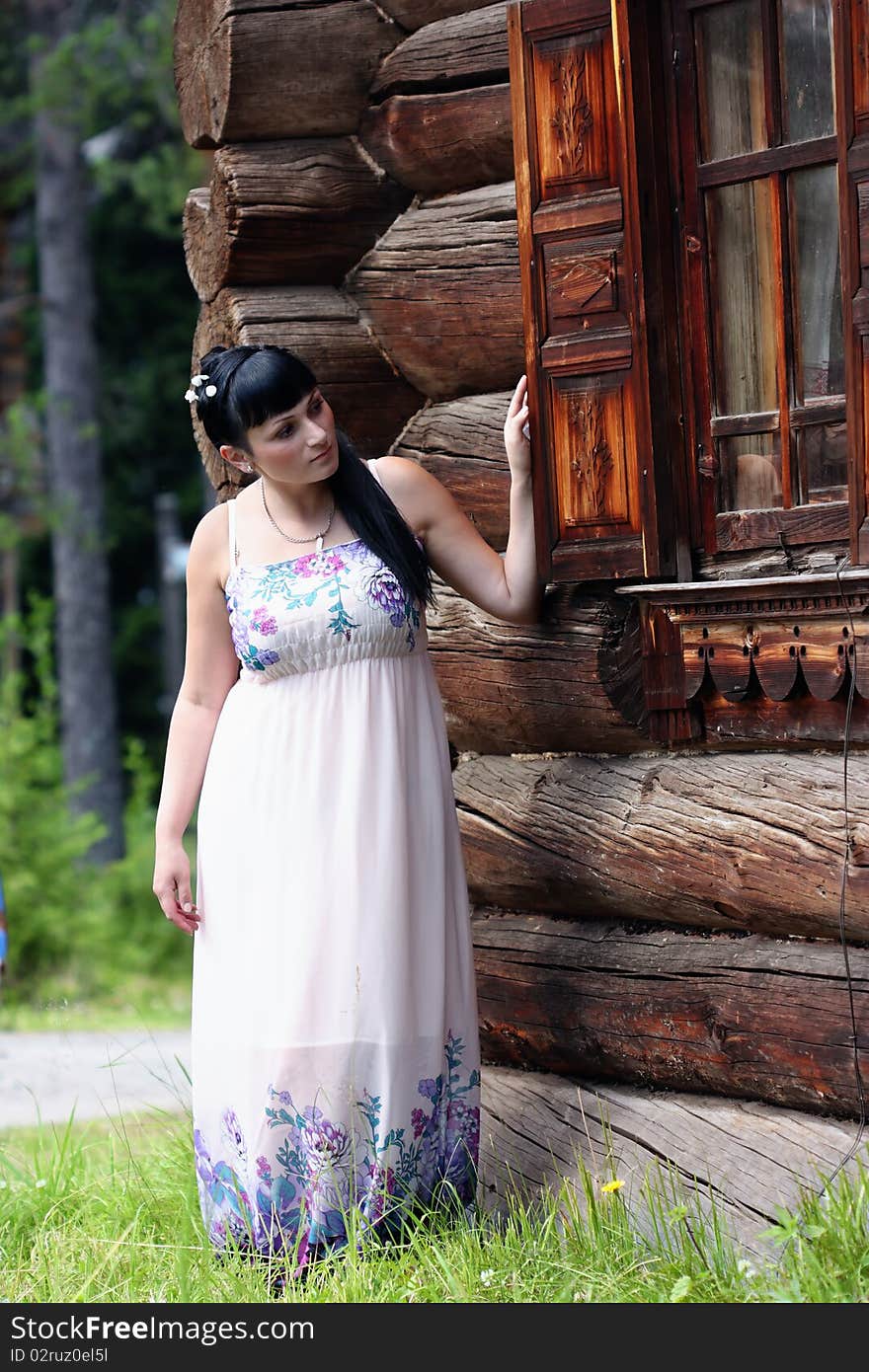 A girl looks out an old shed window. A girl looks out an old shed window