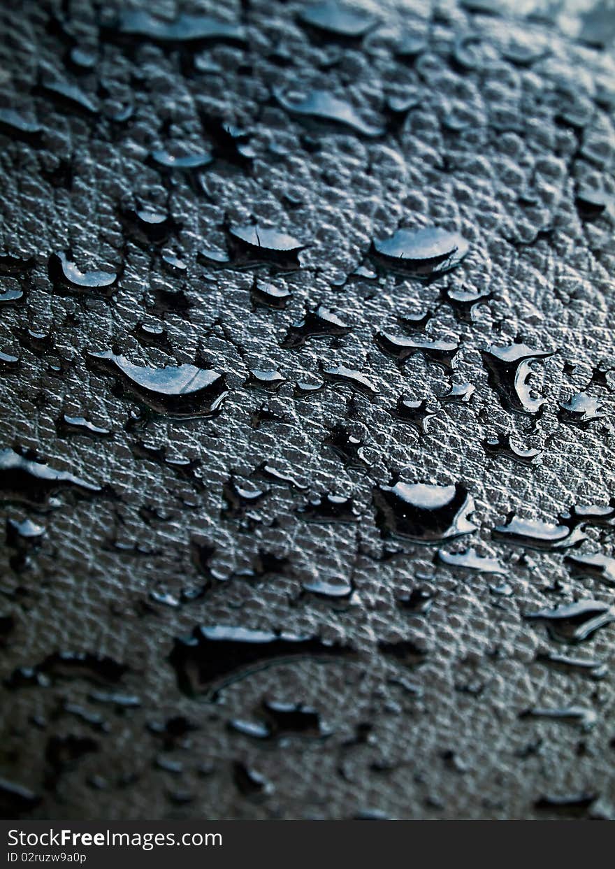 Detail of water drop on black leather