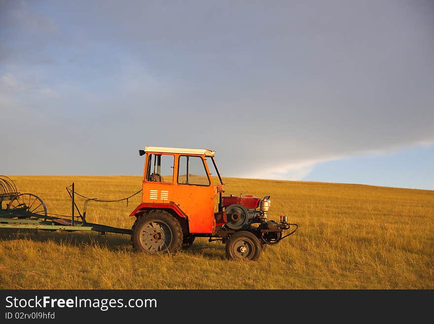 The agricultural machinery in summer prairies