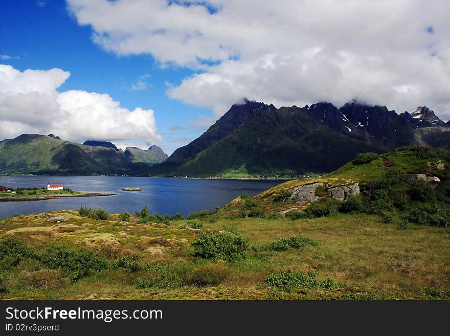 The view on the beauty mountains and lake somewhere in Lofoten islands, Norway. The view on the beauty mountains and lake somewhere in Lofoten islands, Norway