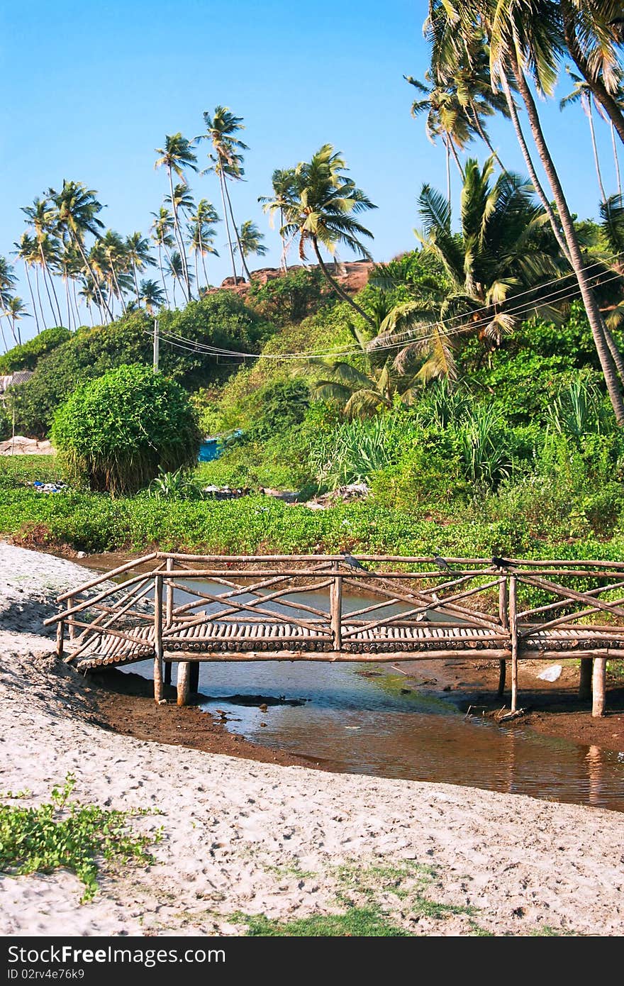 Wooden  bridge cross a small river on Goa coast