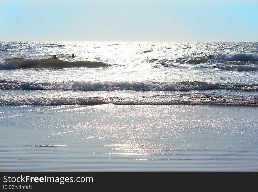 Beautiful shot of  sunset in one of many Goas beachs .Colours are very soft. Sun is reflecting on the ocean. Shallow depth of field.