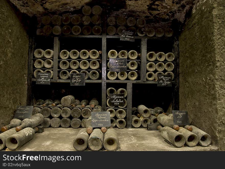 Vine cellar with old and dirty bottles