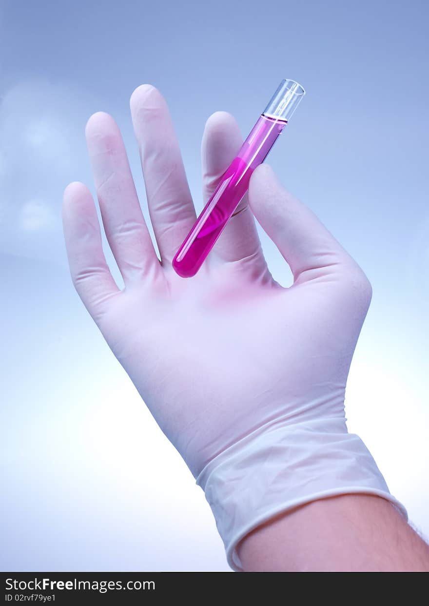 Studio photo of scientist holding vial. Studio photo of scientist holding vial