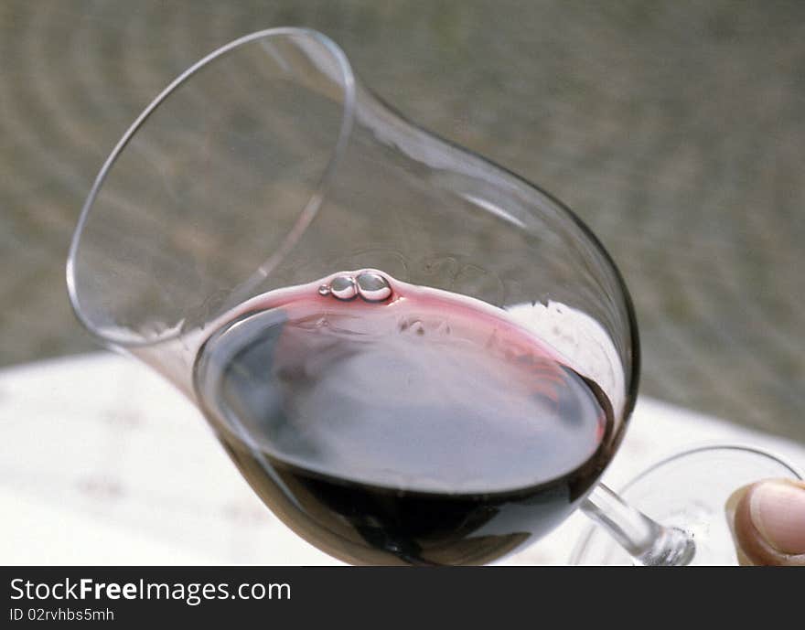 Glass of red wine angular holding