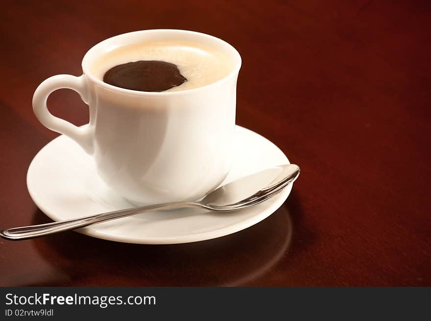 Cup of coffee in a wood table