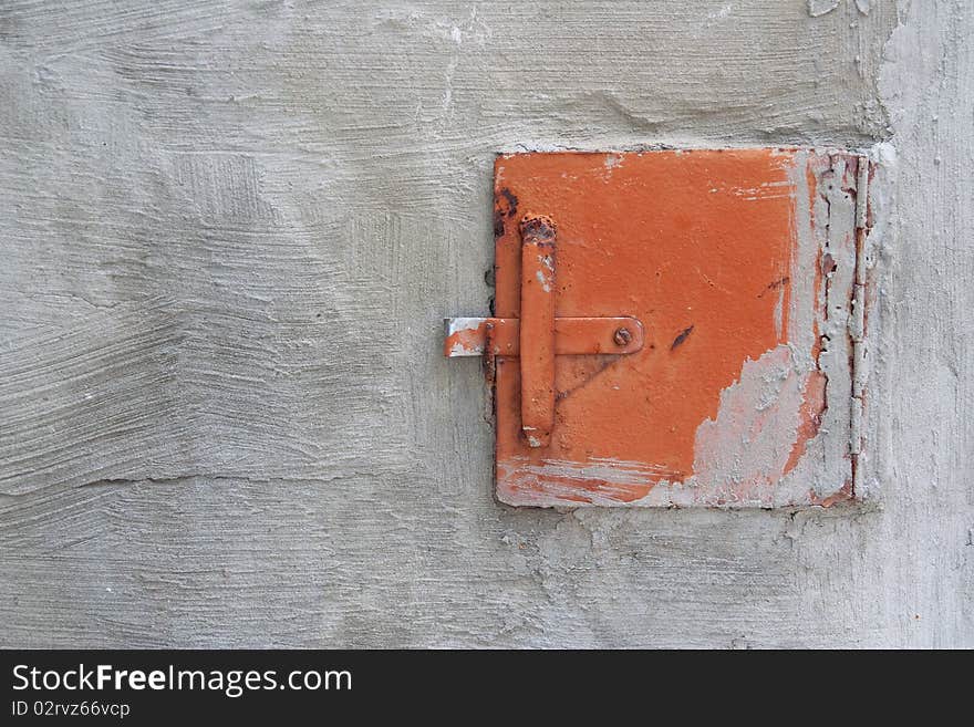 A fragment of the old furnace wall with a shutter. Texture, background. A fragment of the old furnace wall with a shutter. Texture, background