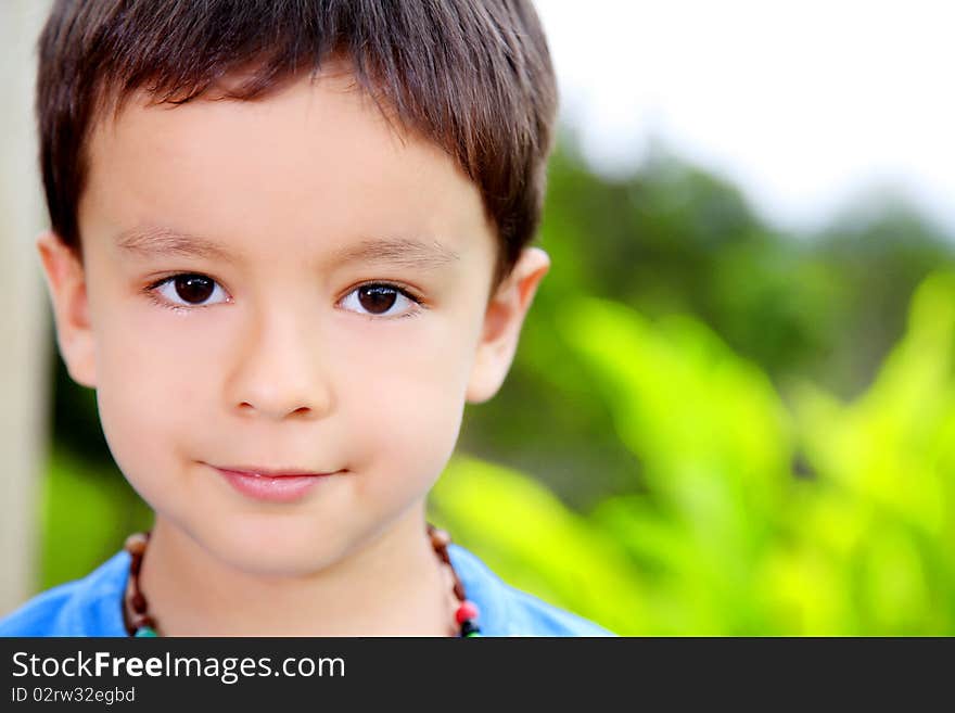 Boy looking at the camera over nature background. outdoor image. Boy looking at the camera over nature background. outdoor image