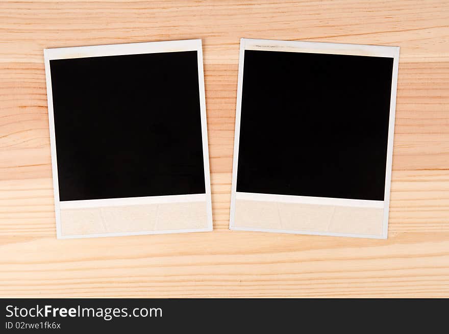 Two old photo frames on a wooden background