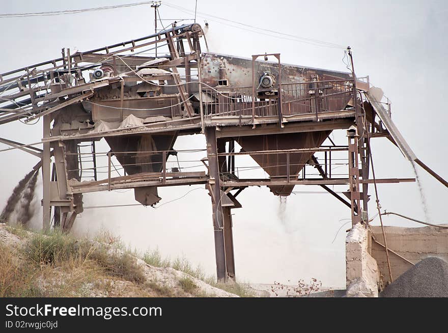 Old, dirty, grey, dusty gravel crusher  machine