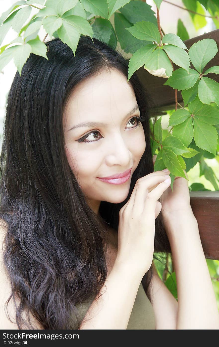 Beautiful girl with long hair in the garden.(taken in August). Beautiful girl with long hair in the garden.(taken in August)