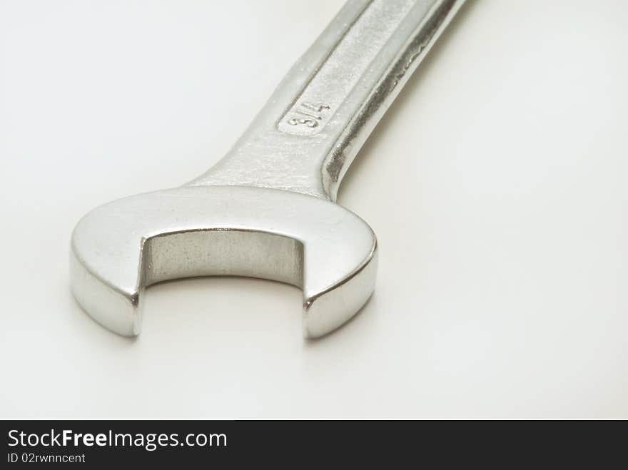 Closeup of single spanner on white background