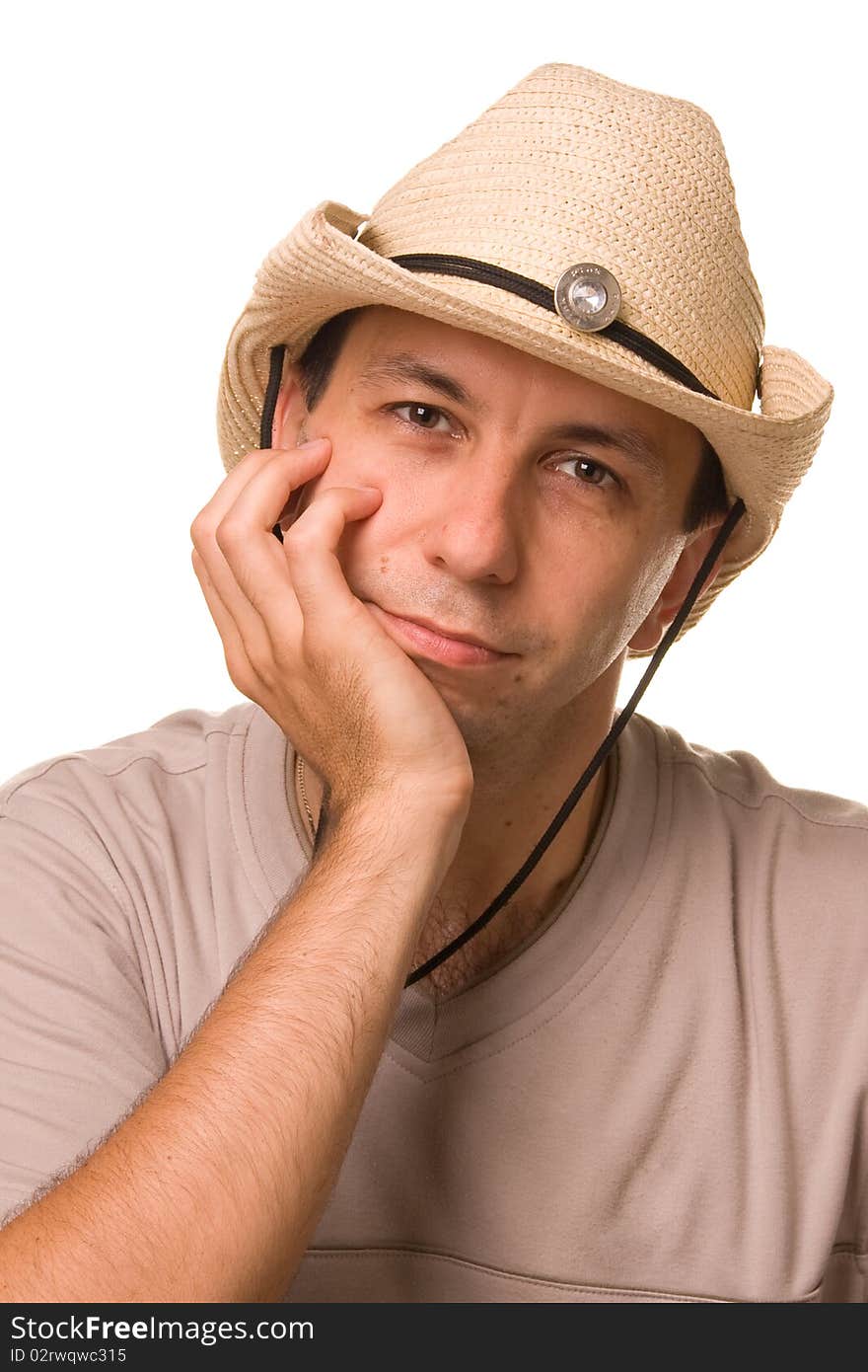 The man in a gray T-shirt puts on a straw hat a head. The man in a gray T-shirt puts on a straw hat a head